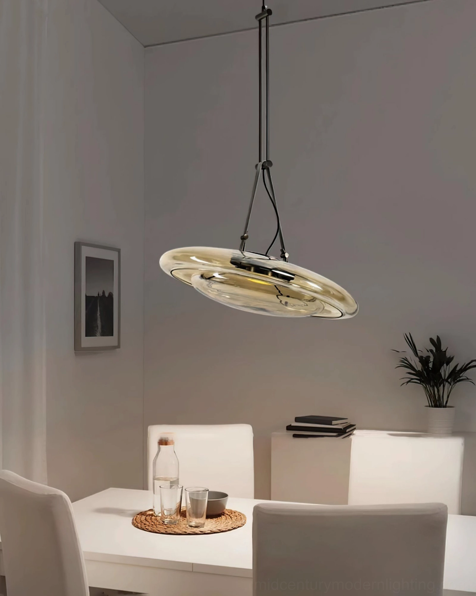 Single Futura pendant lamp above compact dining set in minimalist modern home with wall art