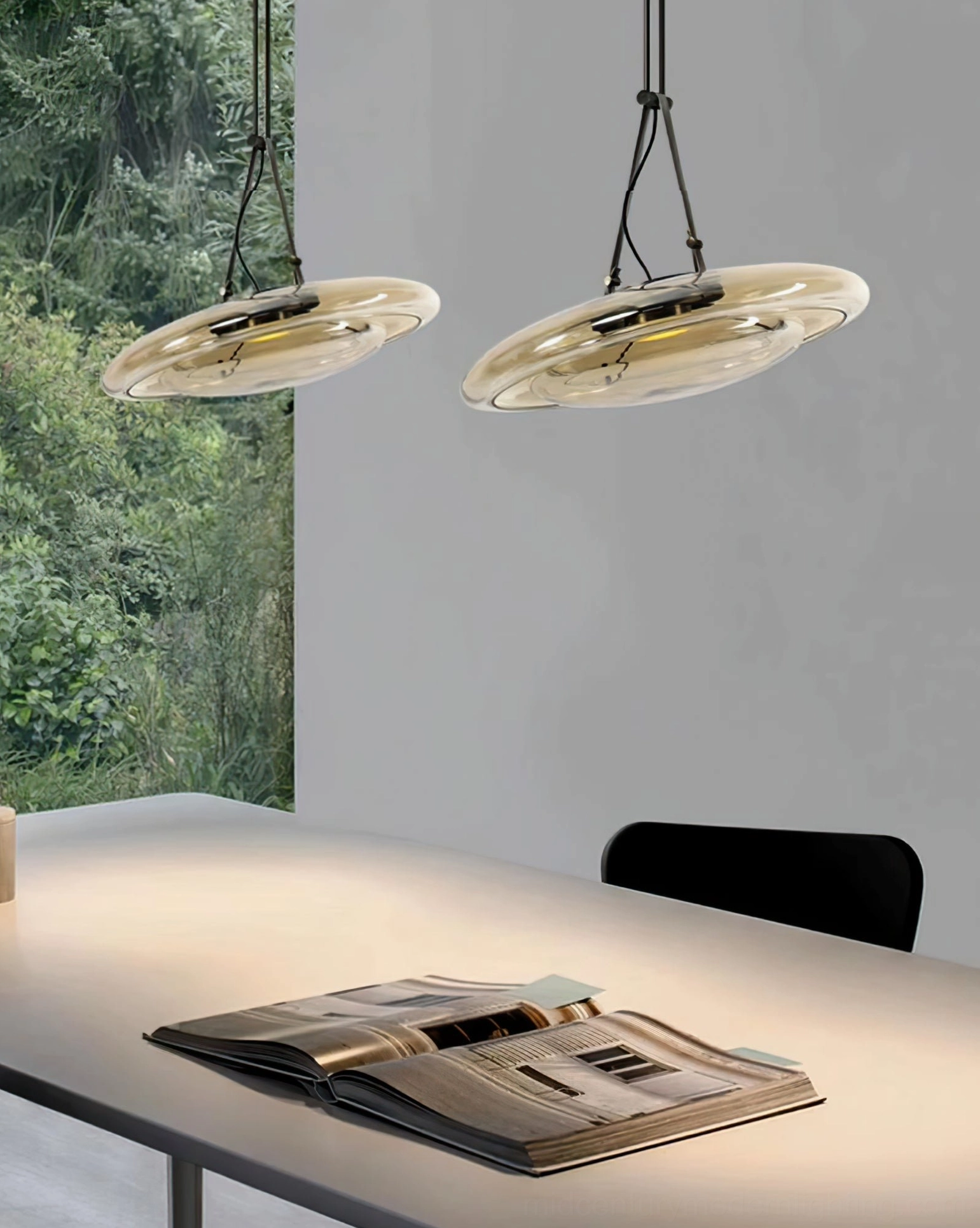 Twin Futura pendant lamps above dining table with natural light from window in modern open-plan kitchen