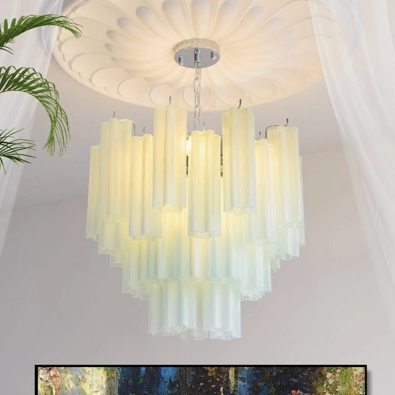 Gabriella tiered glass chandelier in cream white finish installed in sophisticated living room with wall artwork
