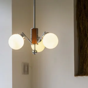 3-light Gaetano sputnik chandelier installed in cream living room, warm frosted glass shades emitting soft ambient lighting