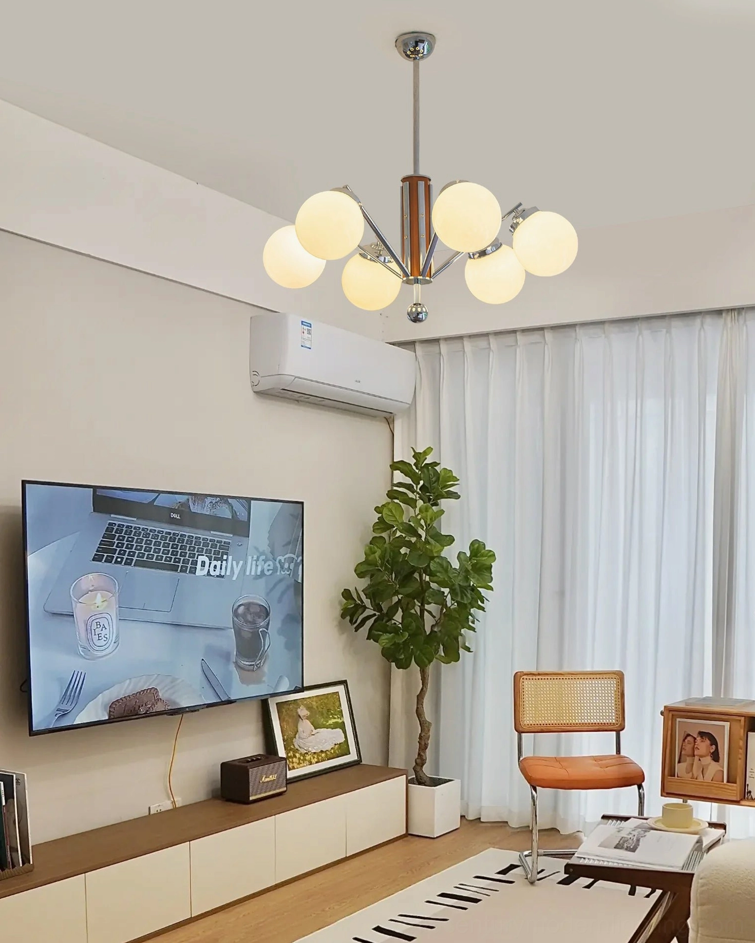 6-head Gaetano sputnik chandelier providing warm ambient lighting in modern living room with TV wall feature