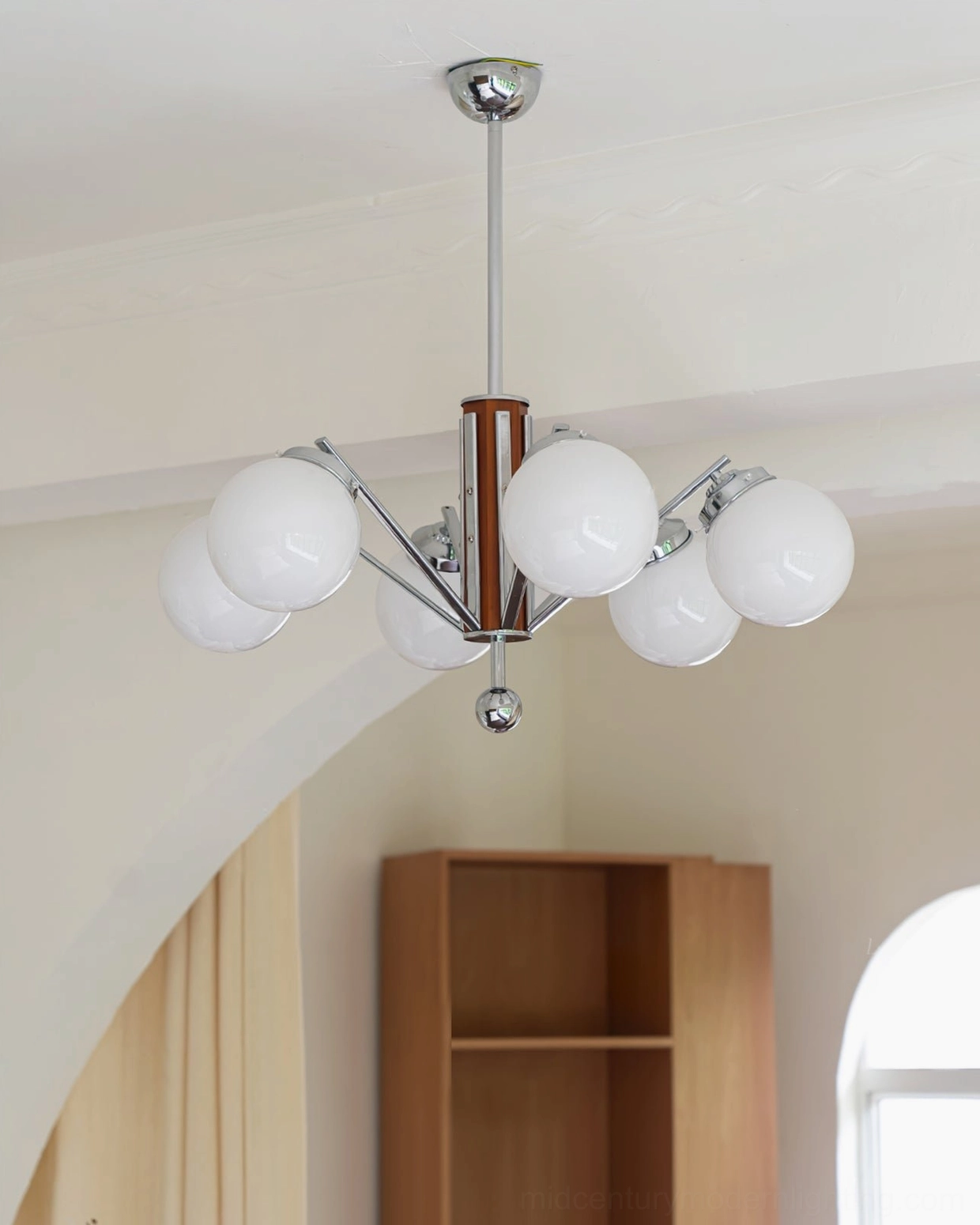 7-light Gaetano sputnik chandelier side profile in minimalist arched doorway interior with chrome frame and walnut structure