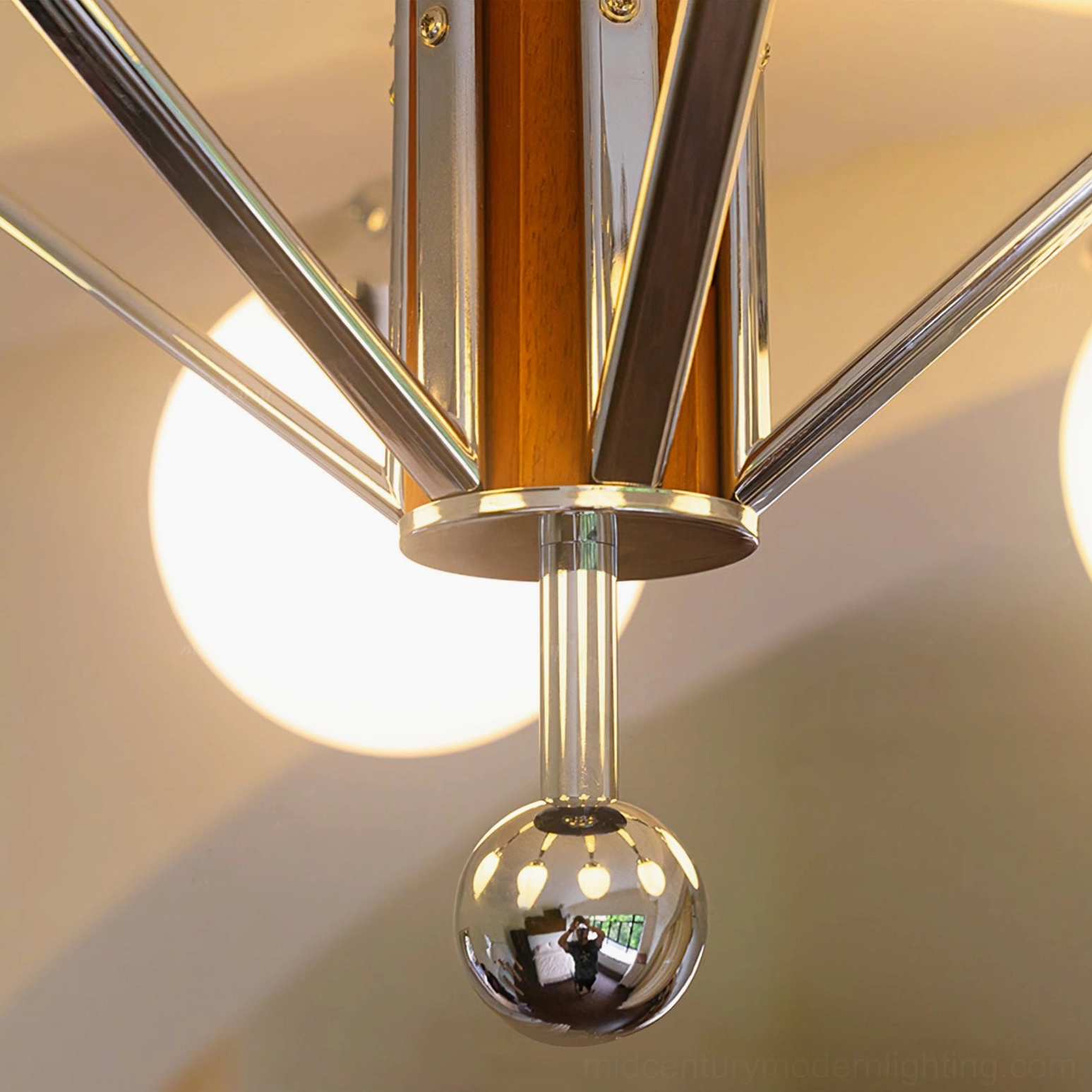 Close-up detail of Gaetano sputnik chandelier bottom assembly featuring polished chrome ball pendant and walnut wood central column
