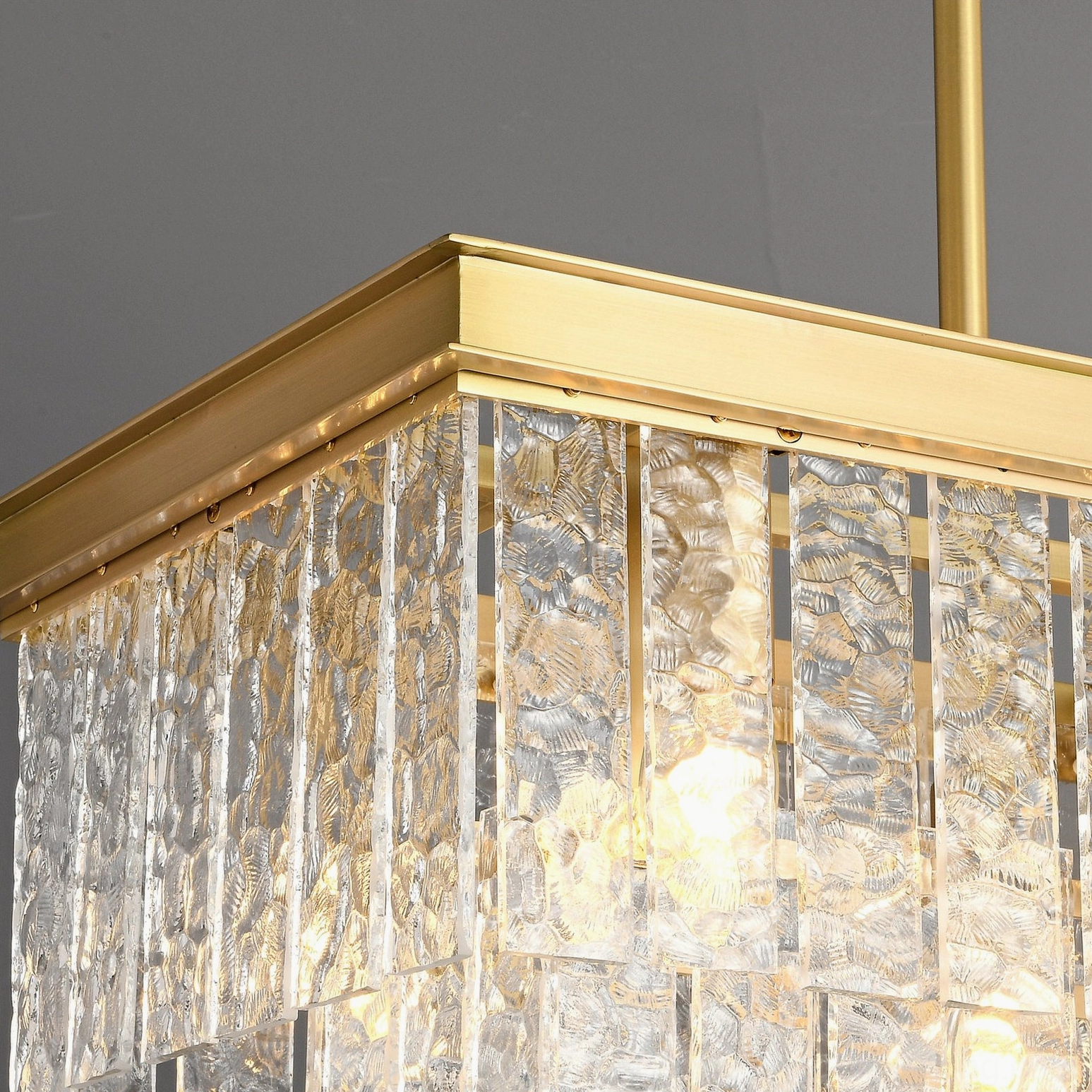 Gaia tiered glass pendant chandelier architectural detail shot showcasing brass frame and geometric design