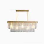 Gaia tiered glass chandelier with brass frame and rippled glass panels, front view with warm glowing bulbs