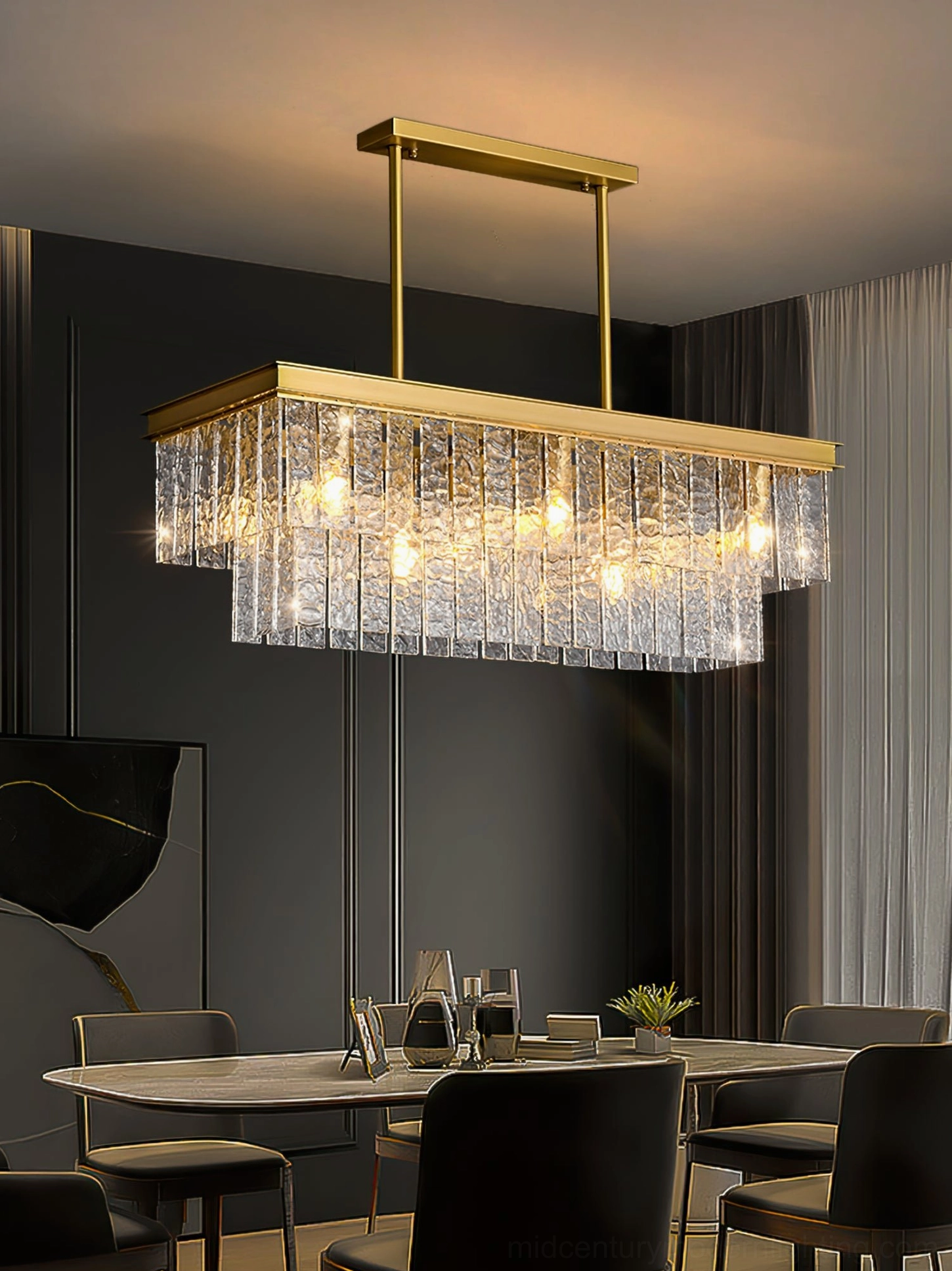 Two-tiered glass chandelier suspended in high-end dark-toned dining room with warm ambient glow