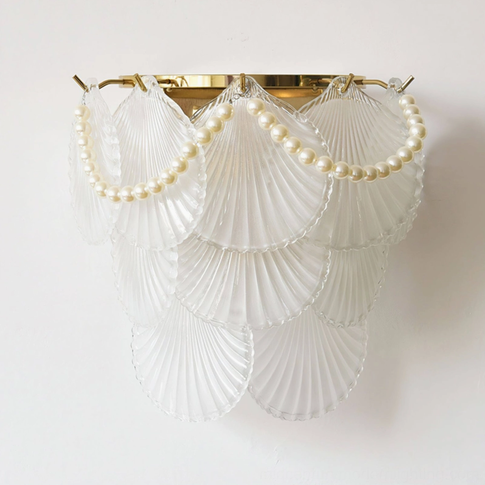 Galerie modern glass wall lamp with clear shell, pearl trim accent, and gold metalwork