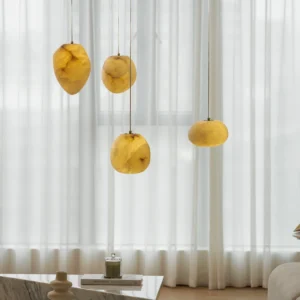 Galet alabaster pendant light glowing warm amber in modern living room with sheer curtains