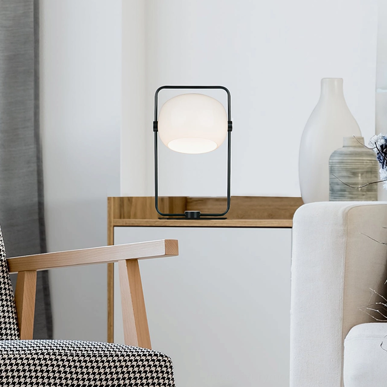 Contemporary black metal table lamp beside modern furniture in living room setting