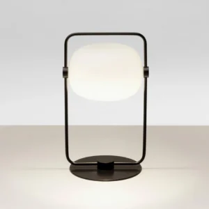 Modern black geometric table lamp with open rectangular metal frame and glass shade, three-quarter view