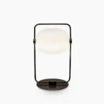 Galet minimalist black metal table lamp with frosted glass shade, front studio view on white background