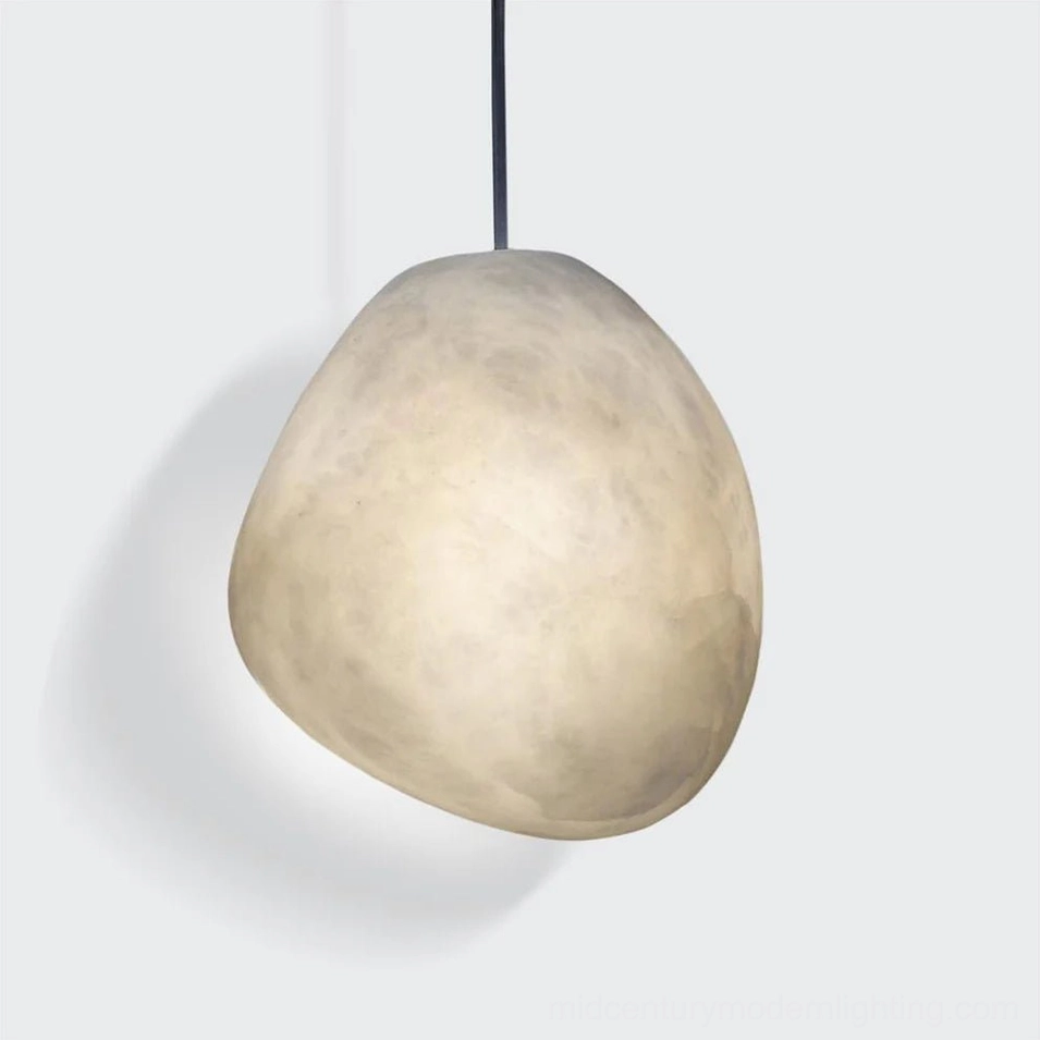 Galet alabaster pendant illuminated at dusk creating warm ambient glow