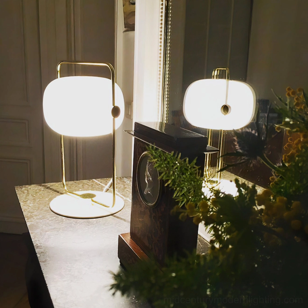 Contemporary metal table lamp with open frame architectural structure and glass shade