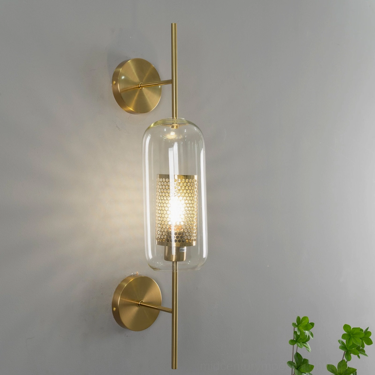 Glass sconce mounted between neutral wall surfaces, gallery-style presentation