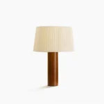 Gallissa mid-century modern wooden table lamp with pleated beige fabric shade on white studio background, front view