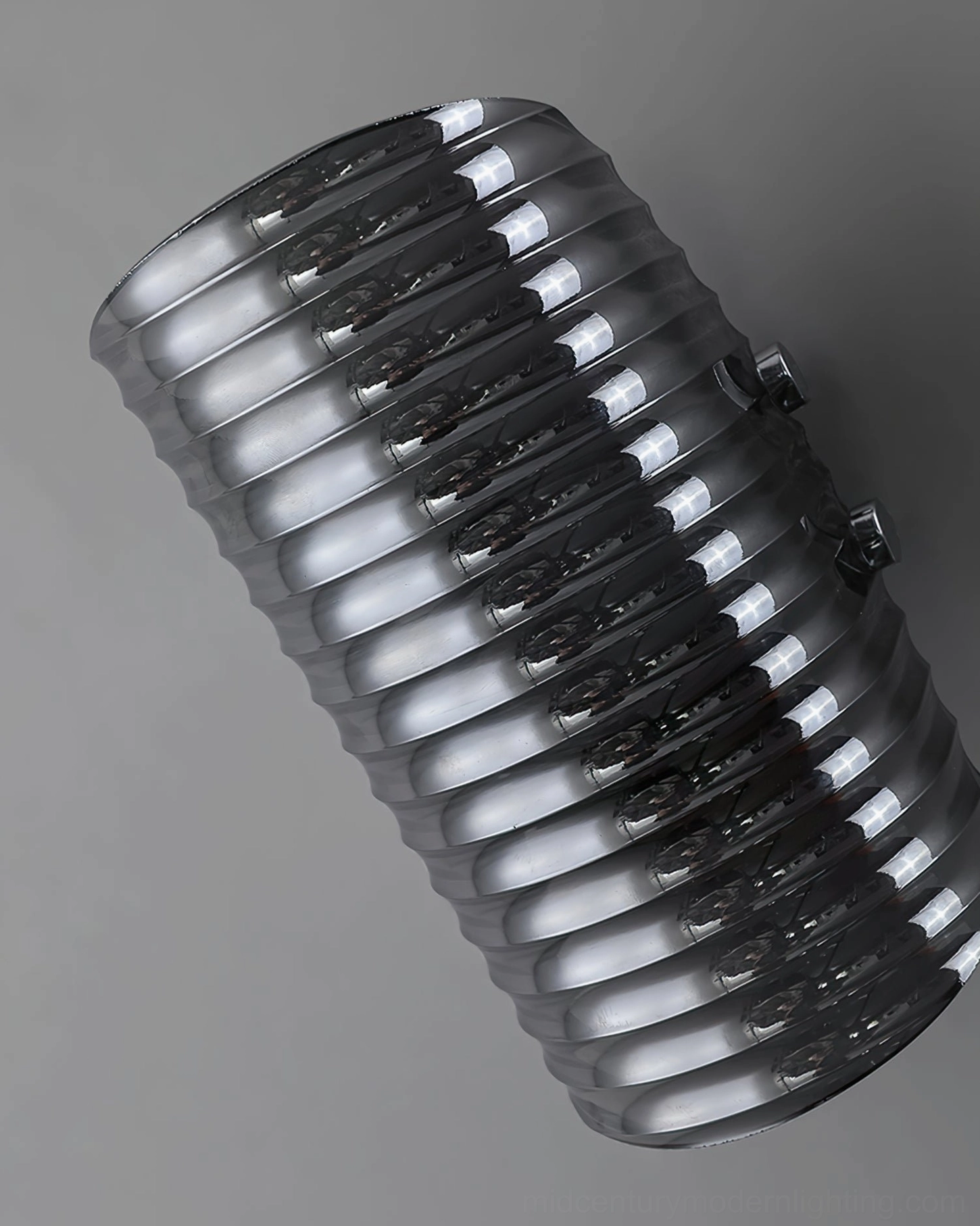 Overhead oblique view of Gatsby ribbed glass wall lamp, showing smoked glass texture and polished metal fixtures against neutral background