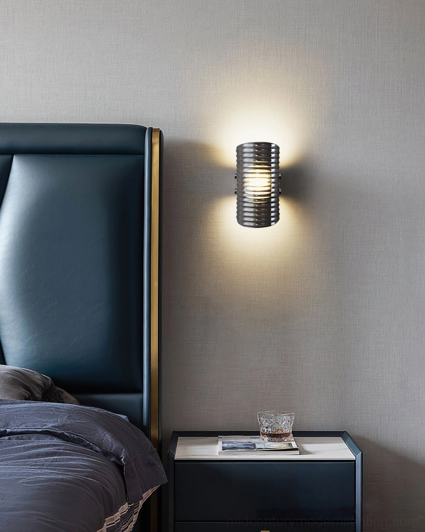 Gatsby mid-century modern wall lamp detail shot emphasizing ribbed glass pattern and warm light diffusion through smoked shade