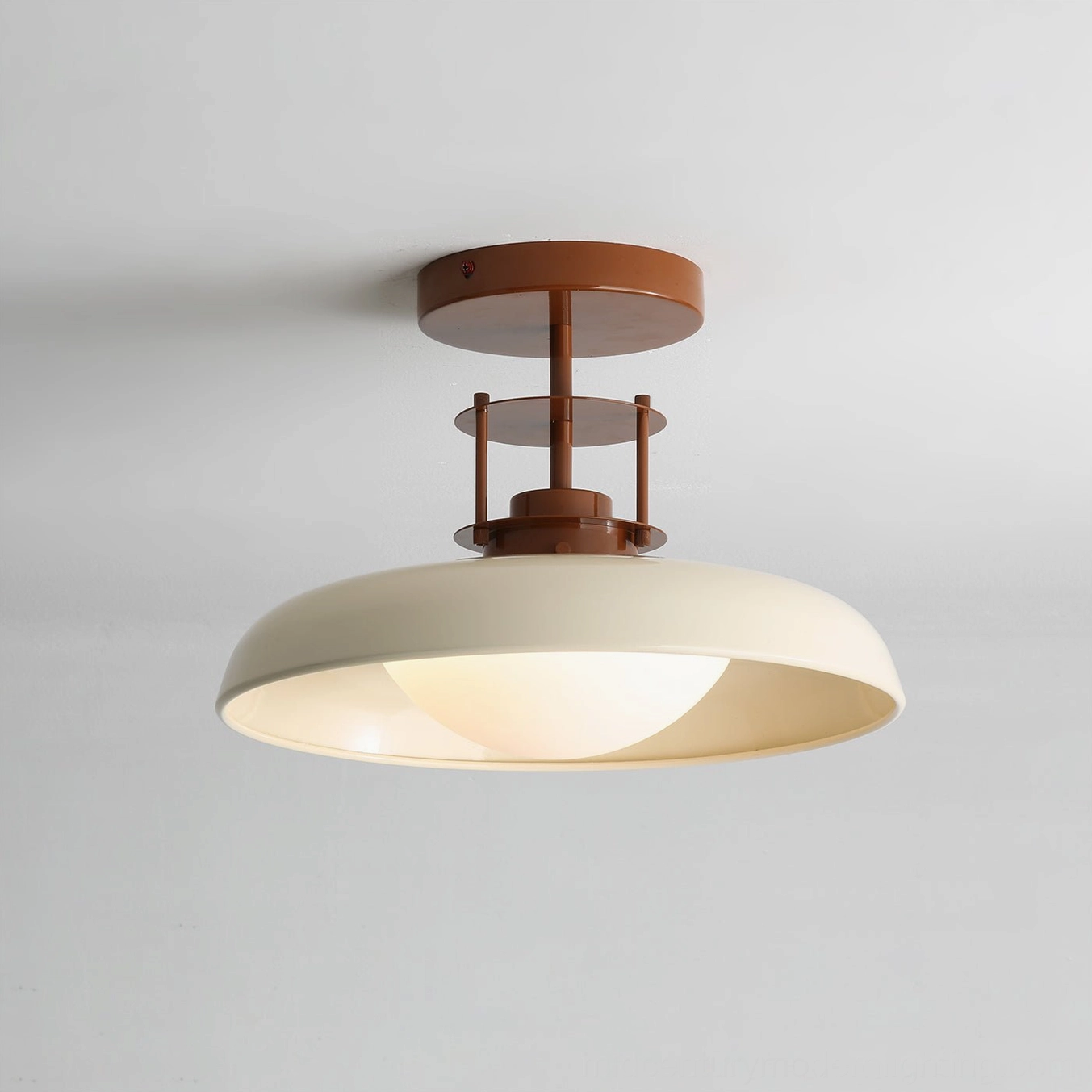 Gavin vintage ceiling lamp illuminated, warm brown metal with glowing cream diffuser, side angle