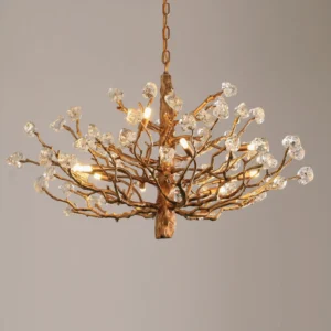 Close-up detail of brass branch chandelier glowing with warm light illuminating hand-blown glass crystal stones