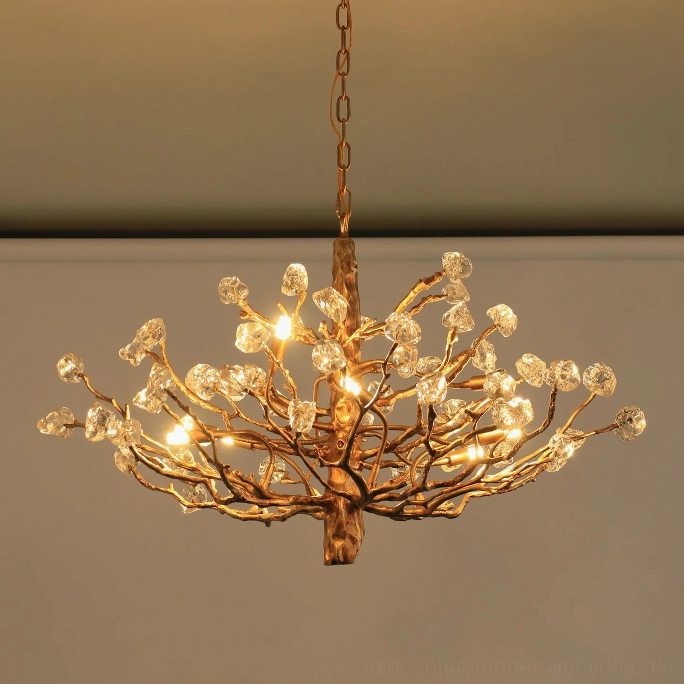 Gemstone branch chandelier detail showing hand-forged brass framework and glass stone accents