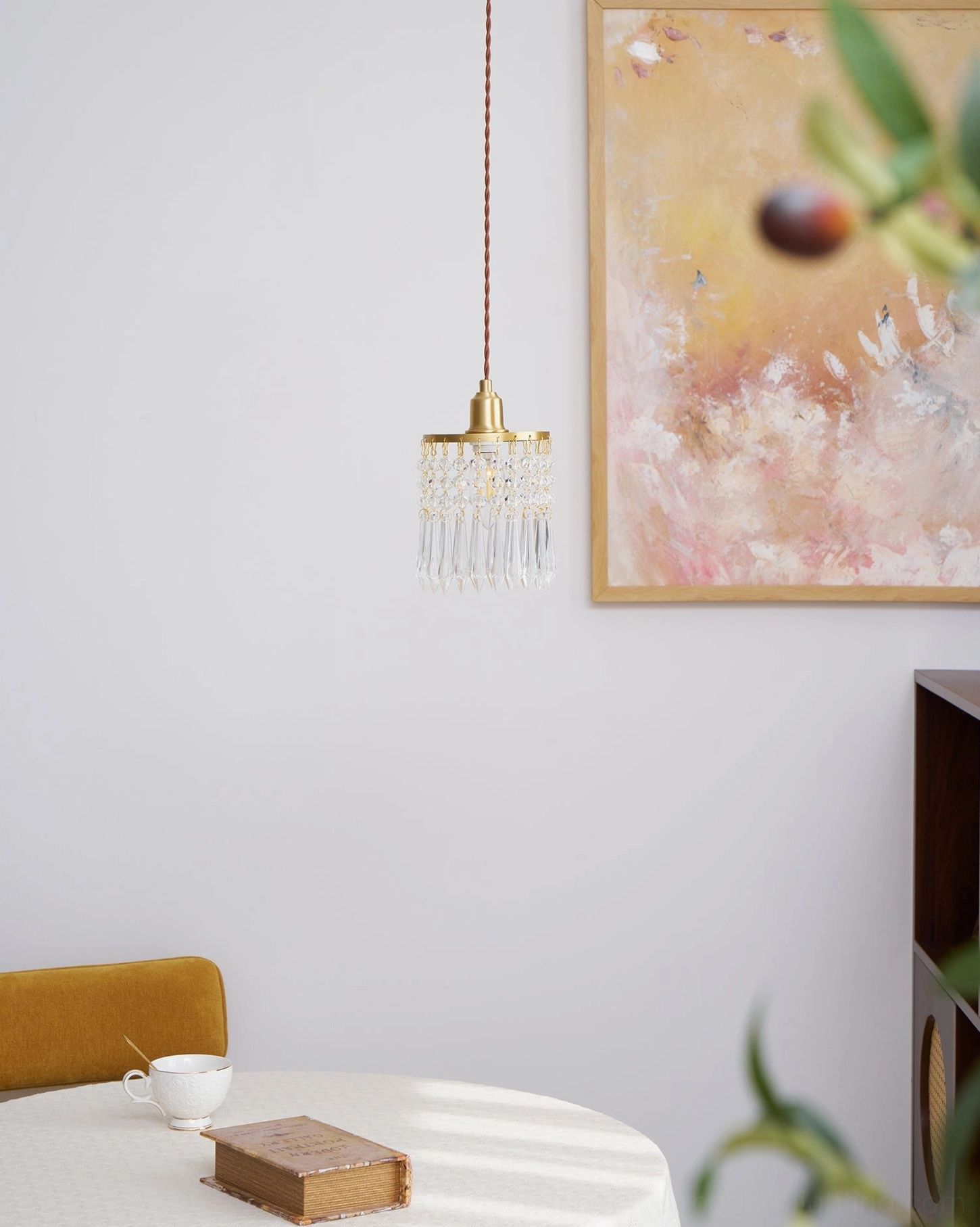 Brass-mounted crystal pendant with clear gemstone-like faceted design