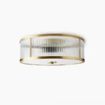 Geneva brass flush mount ceiling lamp with ribbed clear glass shade, front studio view