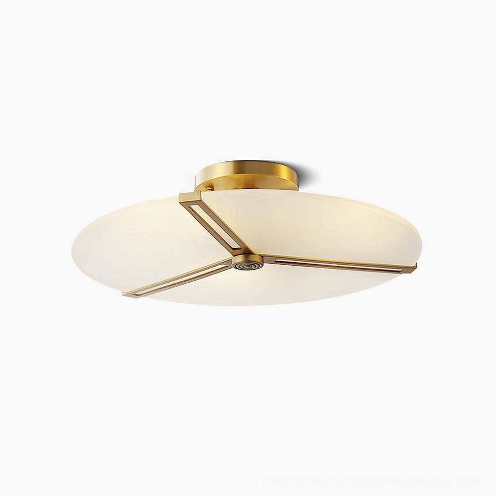 Modern geometric brass flush mount ceiling lamp with frosted white glass disc, front studio view