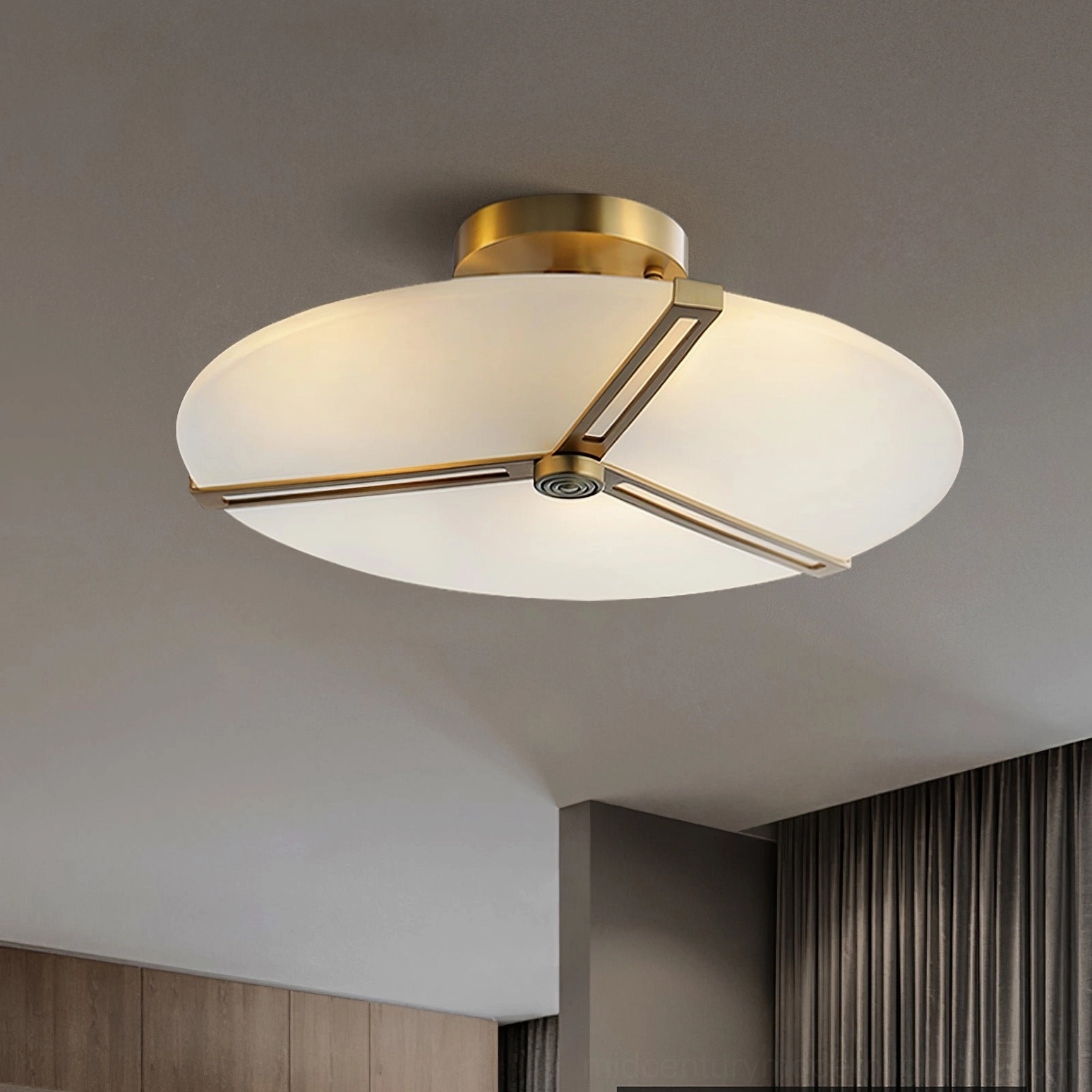 Close-up detail of triangular brass frame and frosted glass shade on modern ceiling lamp