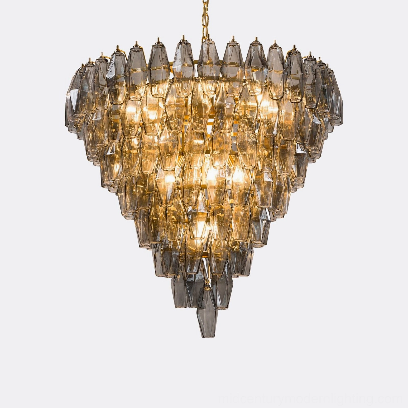 Tiered geometric crystal chandelier hanging from brass chain overhead view