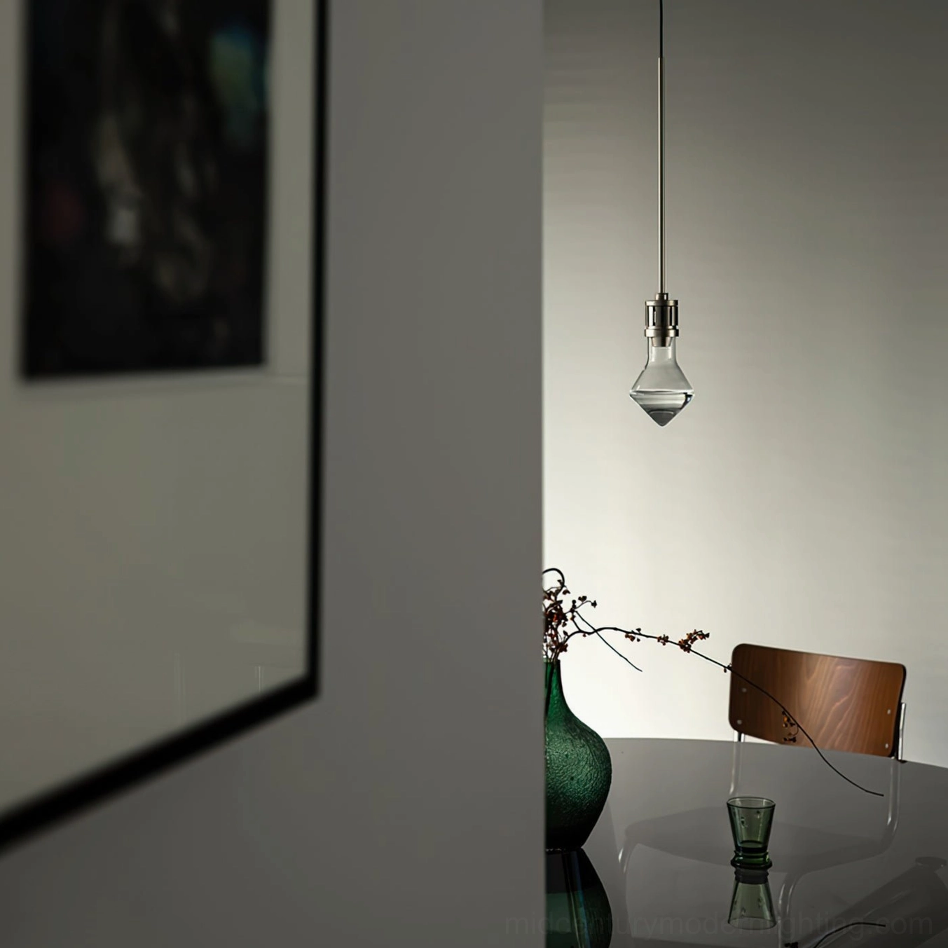 Diamond glass pendant light installed in minimalist dining room corner with warm ambient lighting over dining area