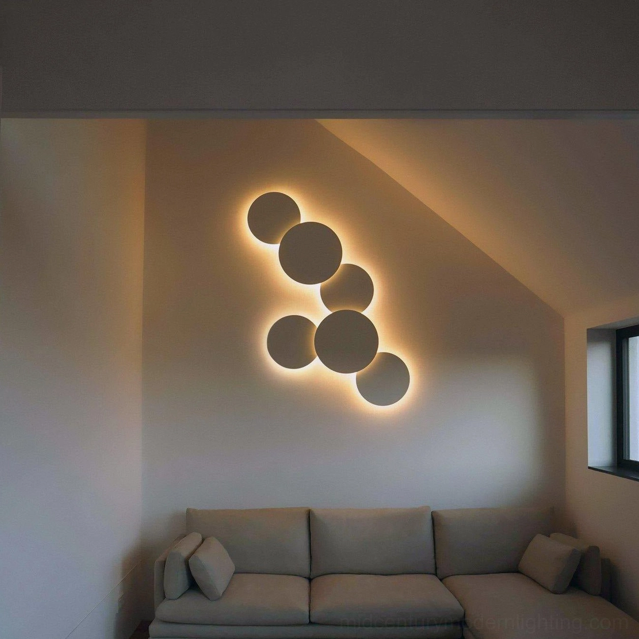Geometric disc wall sconce mounted in contemporary interior showing mathematical form and warm light diffusion