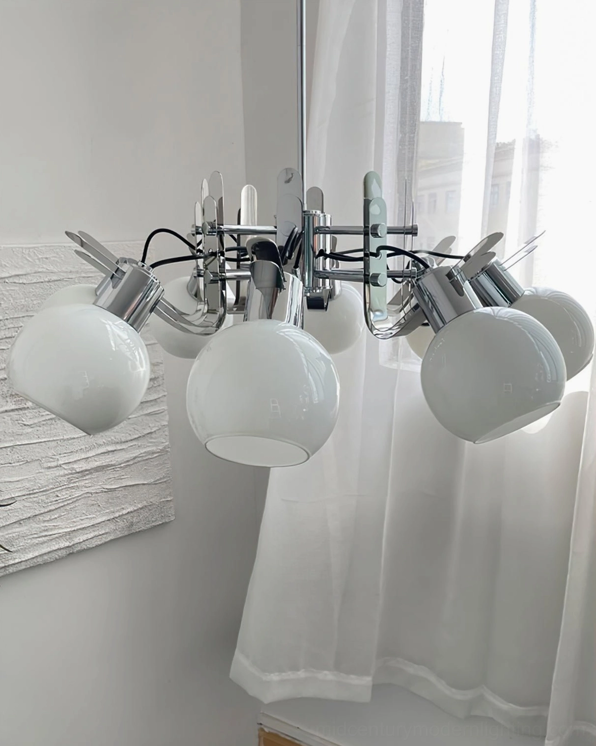 Three-head geometric glass chandelier positioned as architectural focal point in contemporary interior