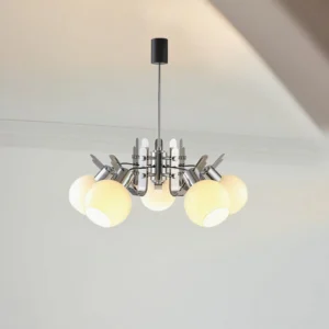 Lit geometric glass pendant chandelier illuminating residential interior corner with warm glow