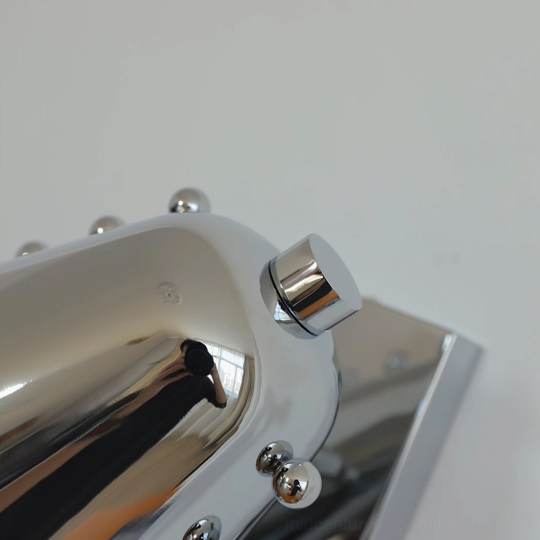 Geometric wall lamp close-up showing premium metal construction and finish quality details