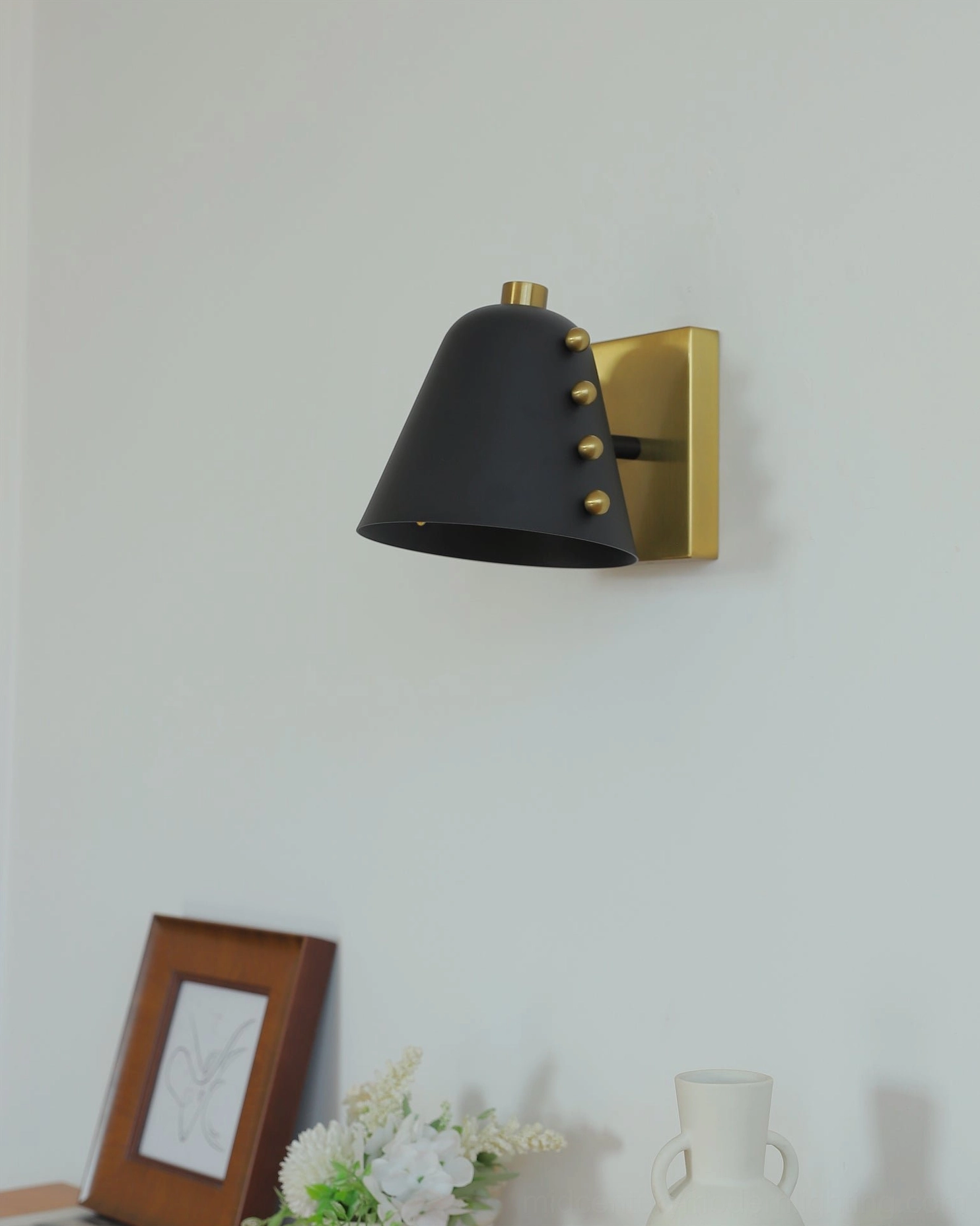 Geometric wall lamp in contemporary styled interior with complementary decor elements