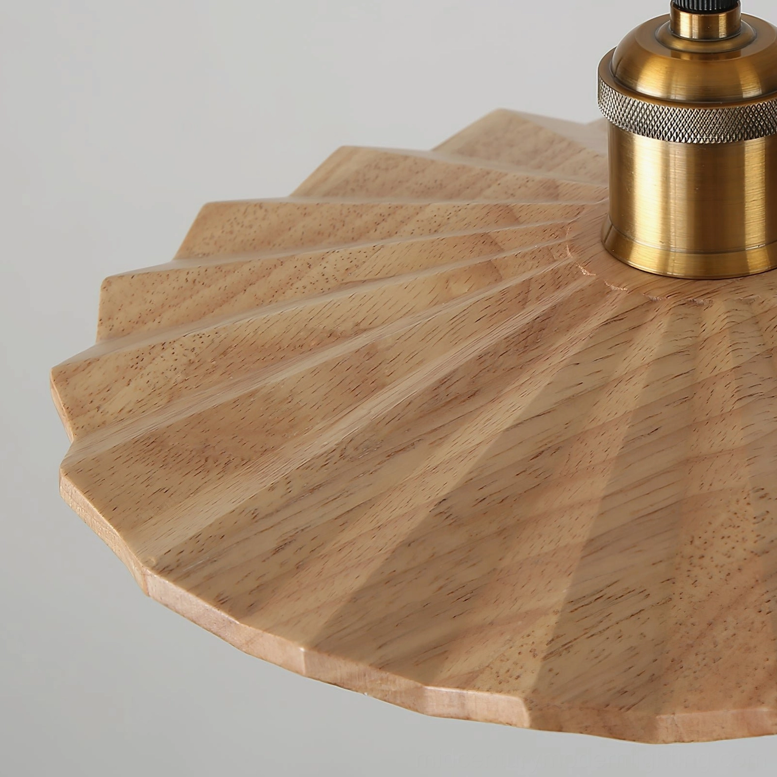 Geometric walnut wood pendant light shown at different angles displaying zigzag shade design and brass components