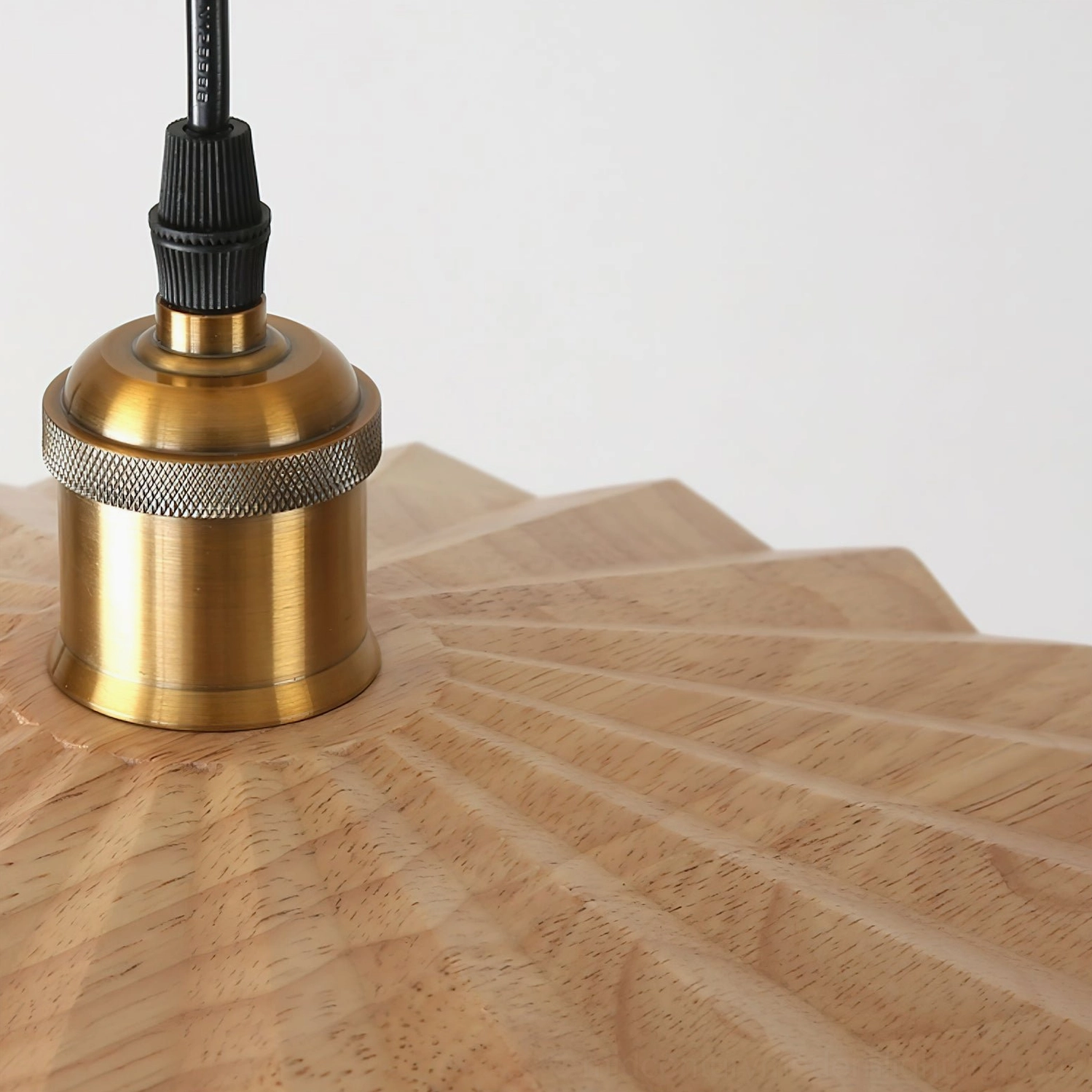 Geometric wooden pendant light with warm brass hardware and precision-cut shade pattern - mid-century modern fixture detail