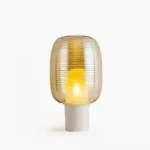 Ghia mid-century modern table lamp with cognac amber ribbed glass shade and white base, front studio view