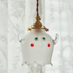 Vintage ghost pendant lamp hanging from twisted brown fabric cord indoor curtain backdrop