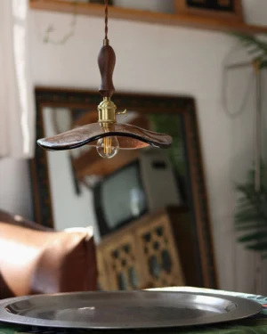 Overhead view of Gideon retro pendant light illuminating vintage dining corner with warm amber glow, showing wavy glass texture