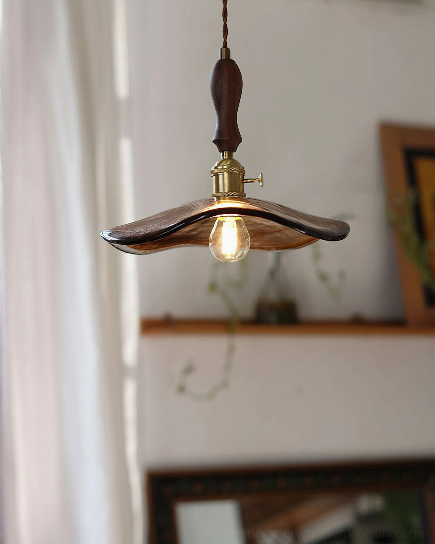 Gideon amber glass pendant featuring exposed warm Edison-style bulb in minimalist vintage room with bright natural light