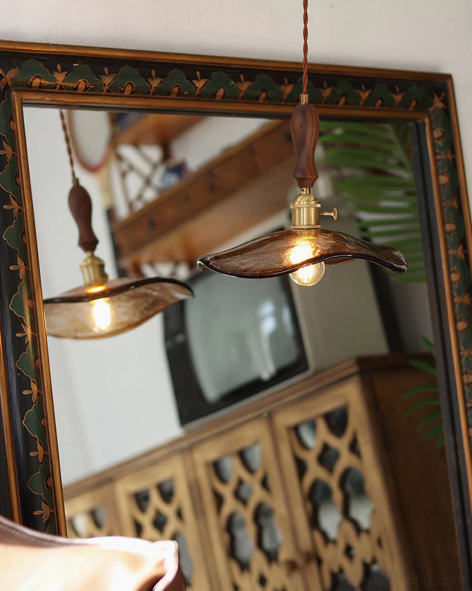 Gideon mid-century modern wavy glass pendant light with brown amber shade and walnut wood finial, artistic product photography