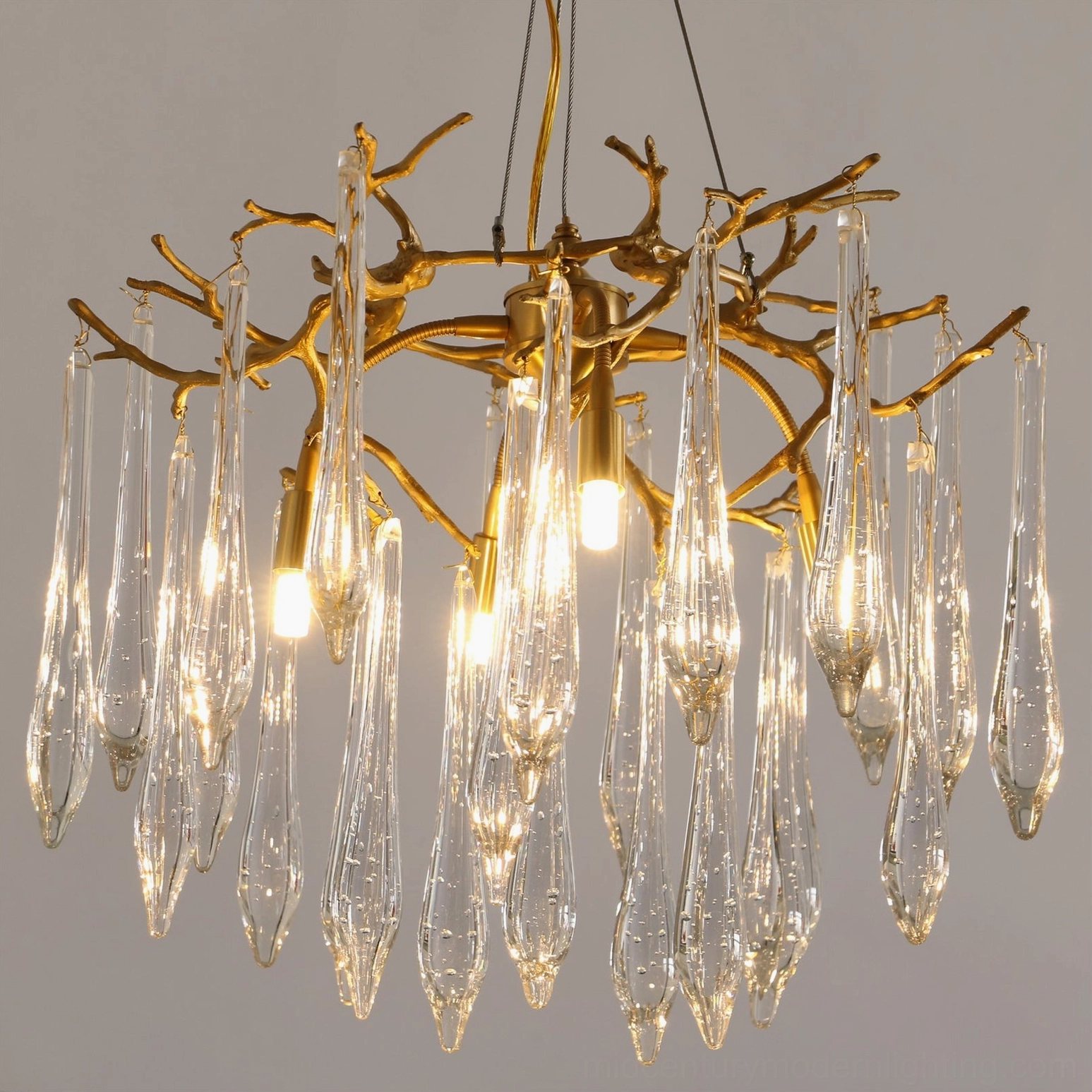 Gieslinde Branch Chandelier illuminated with multiple lit G9 bulbs creating warm ambient light