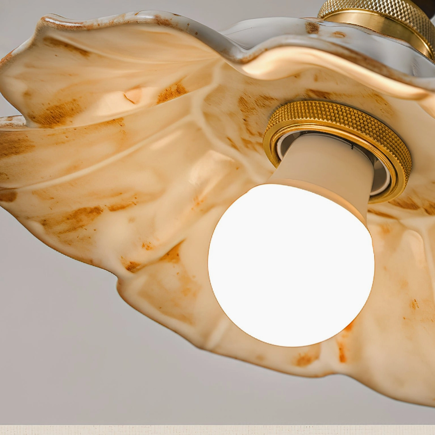 Gigaro artisanal pendant light highlighting handcrafted ceramic ruffled shade and vintage brass design details