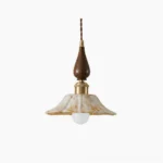 Gigaro ceramic pendant light with ruffled marbled shade, wood top, and brass hardware on white background