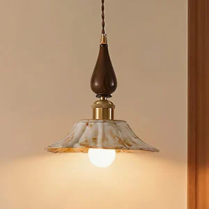 Mid-century modern Gigaro pendant light with twisted cord, wood grain hardware, and vintage brass accents