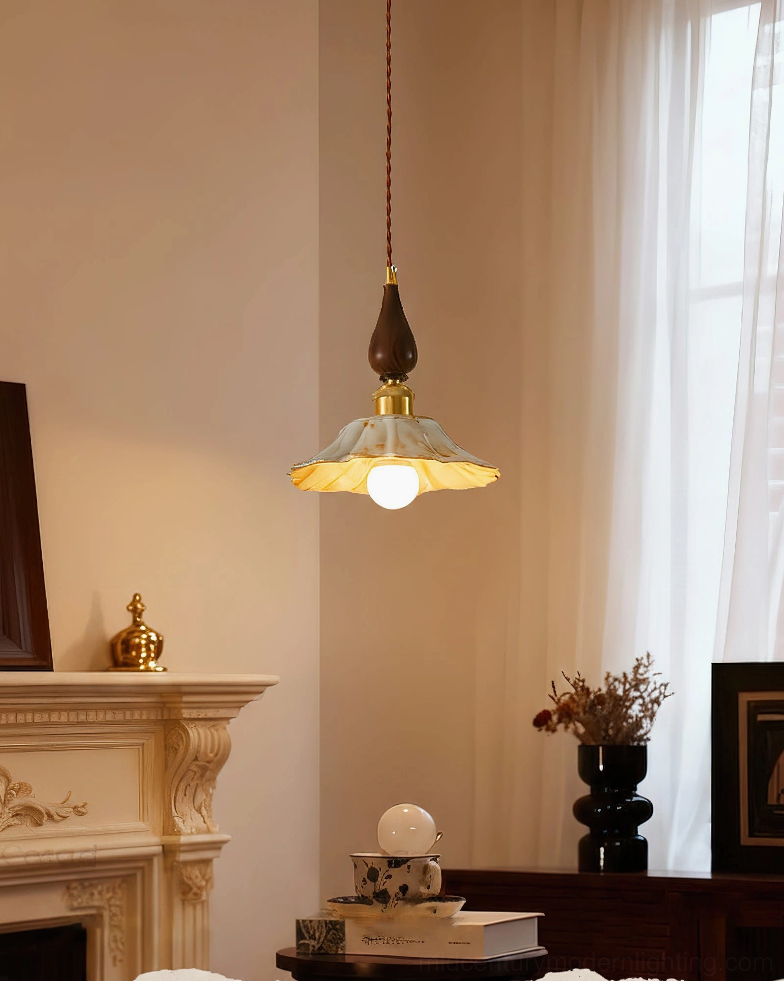 Gigaro pendant light hanging in vintage living room with fireplace, demonstrating mid-century modern interior styling
