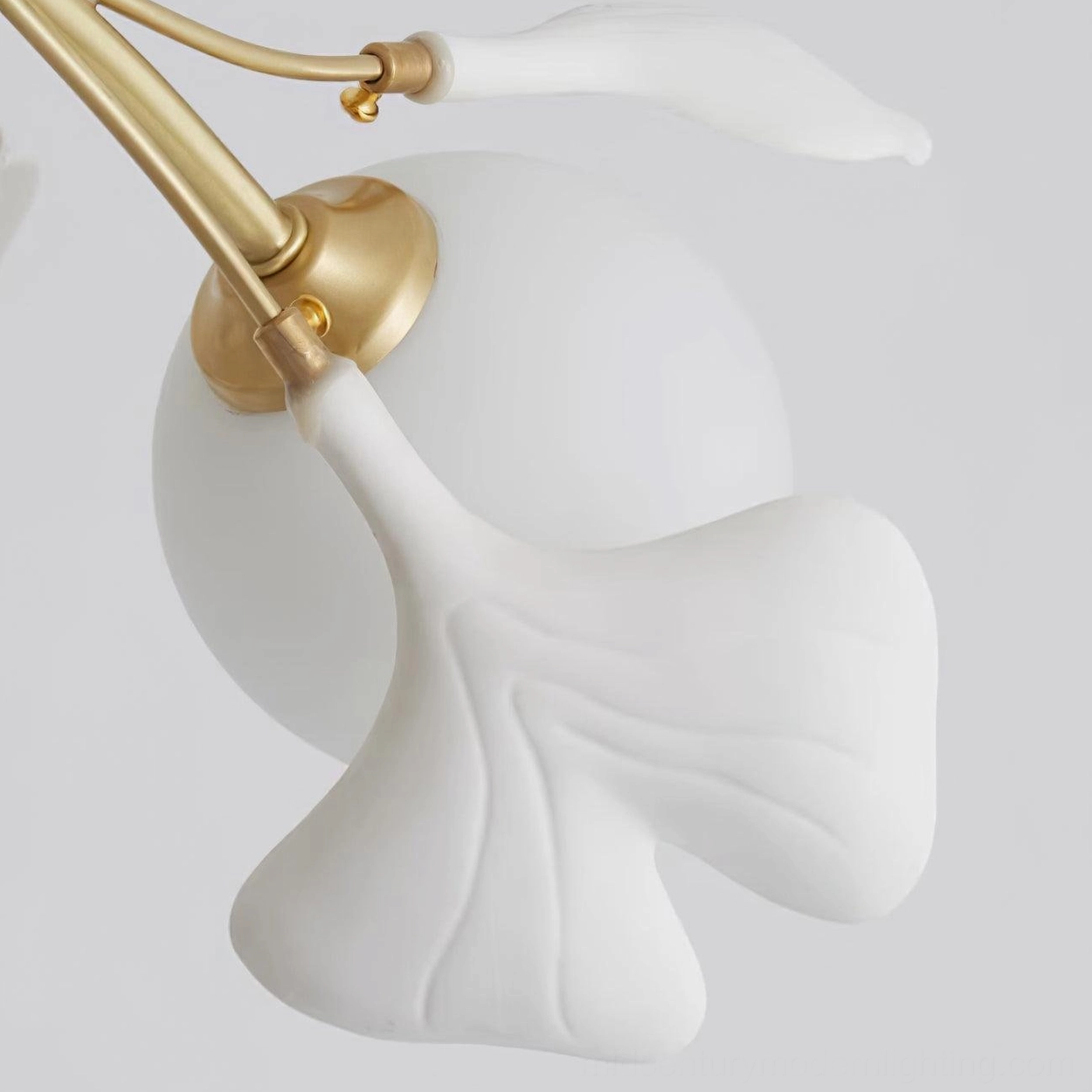 Eight-head gingko chandelier configuration showing brass branch spread and ceramic leaves