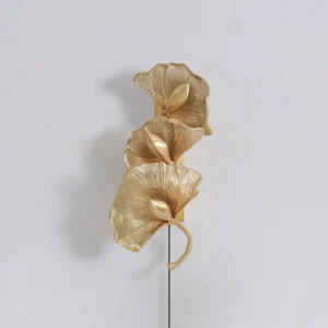 Brushed brass ginkgo leaf wall lamp showing detailed metallic texture and veining, close studio perspective