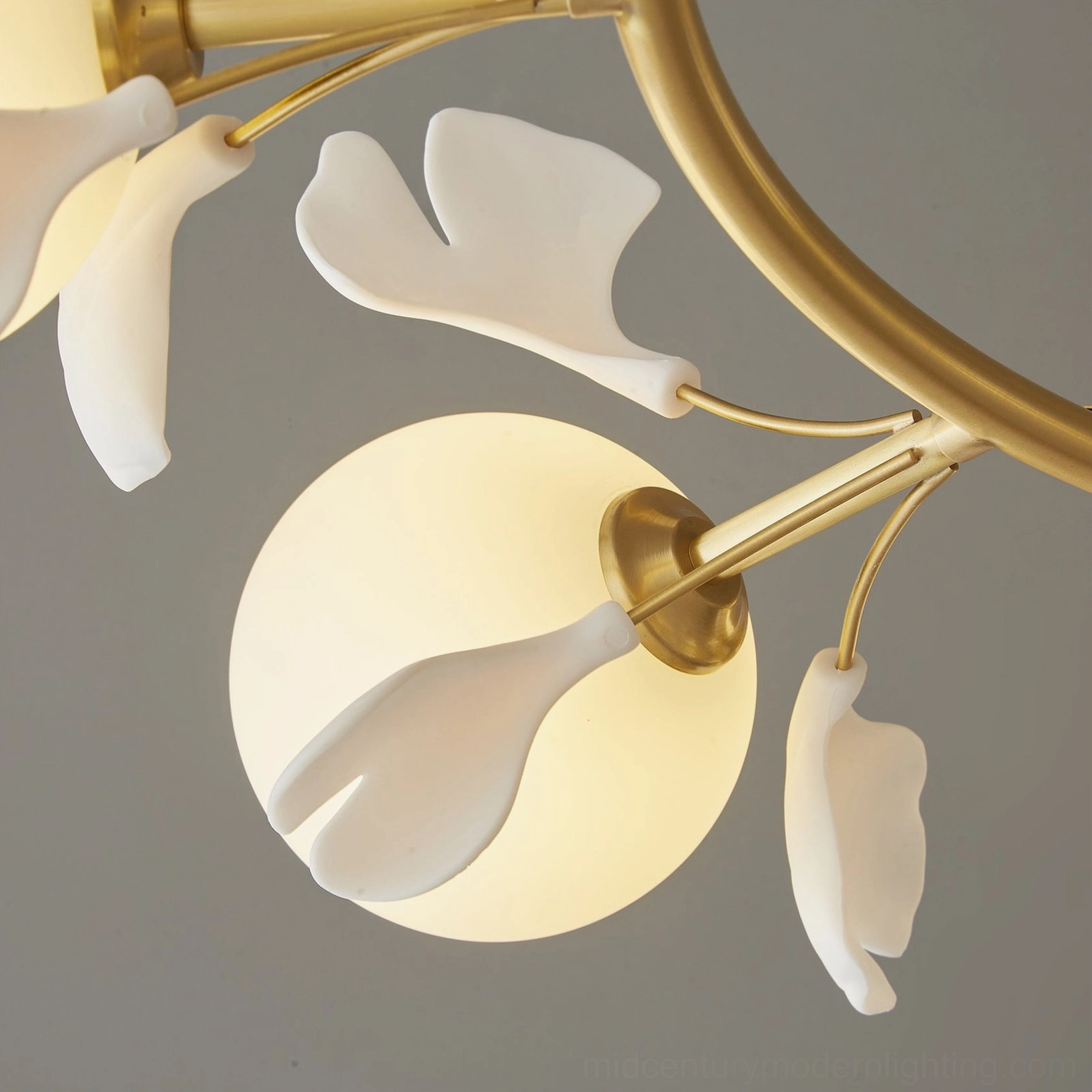 Extreme close-up brass joint and frosted glass shade ginkgo chandelier